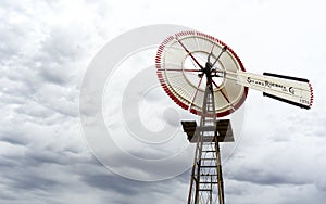 Single old historic wind wheel or wind pump made of wood and metal up close