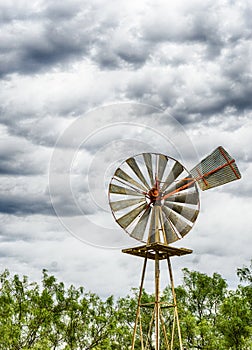 Single old historic wind wheel or wind pump made of wood and metal up close