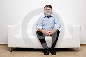 Single old men on white couch