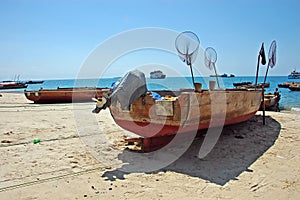 Single old wooden ship on the beach in Zanzibar