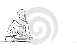 Single one line drawing Arabian woman pouring cooking oil from bottle into frying pan on stove. Prepare food in kitchen. Cooking