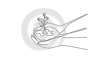 Single one line drawing hand holding sprout a money tree in nature green forest. Businessman hand hold growing money tree.