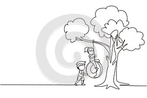 Single one line drawing happy boys and girls playing tire swing under tree. Kids swinging on tire hanging from tree. Children