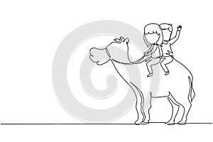 Single one line drawing happy little boy and girl riding camel together. Children sitting on hump camel with saddle in desert.