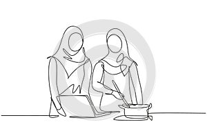 Single one line drawing two Arabian woman cooking dinner has video call conversation in kitchen and talking with friend using