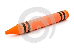 Single orange crayon isolated on white photo