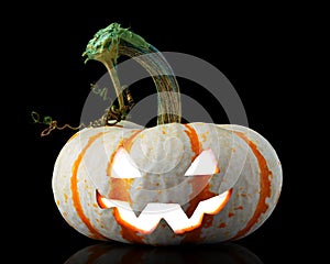Single orange striped pumpkin jack-o-lantern on black photo