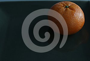 Single Oranges on Dark Background