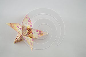 Single Origami flower on white background