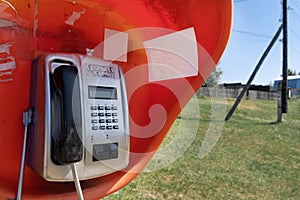 A single, outdated Braille phone booth operates in a distant village on the banks of a large river