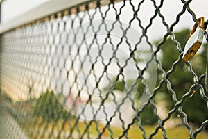 Single padlock attached to a metal fence