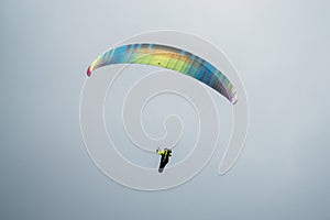 Single paraglider pilot flying