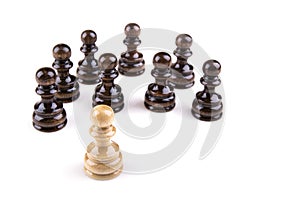 Single pawn against all black pawns isolated on white background - concept of an unequal struggle