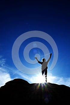 Single Person Triumphant Reaching Peak Summit on Mountain with S