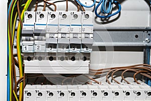 Single-phase fuses in the OFF and ON position, placed in the home fuse box, visible electric wires.