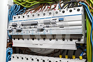 Single phase fuses in OFF and ON position and residual current protection in ON position. Many gray switches in a row, home fuse b