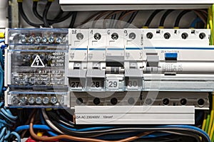 Single phase fuses in OFF and ON position and residual current protection in ON position. Many gray switches in a row, home fuse b