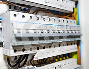 Single-phase fuses and three-phase fuses in the OFF position, placed in the home fuse box, visible electric wires.