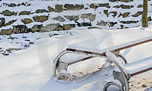 Single picnic table covered in snow