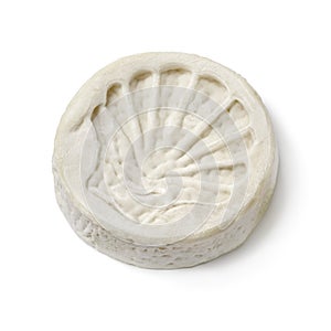 Single piece of French le Compostelle goats cheese close up on white background