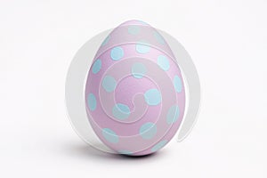 Single pink painted Easter egg with blue dots