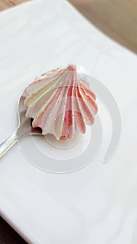 Single pink twirl meringue closeup