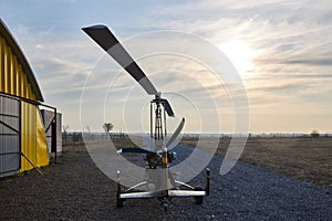Single place ultralight homemade gyroplane stands at the airport near the hangar in the early morning. photo