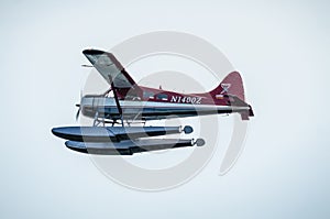 Single Prop Airplane Pontoon Plane flying in alaska mountains
