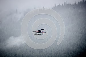 Single Prop Airplane Pontoon Plane flying through fog over Alaska Last Frontier