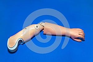 Single prosthetic arm over blue background