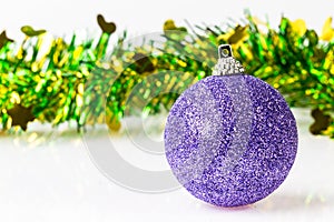 single purple ornament with christmas tinsel