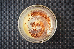 Single ramekin of caramelized custard ready for serving as a dessert