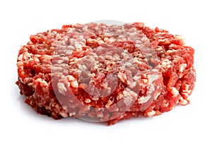 Single raw hamburger patty isolated on white.