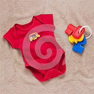 Single red baby bodysuit with plastic toy keys