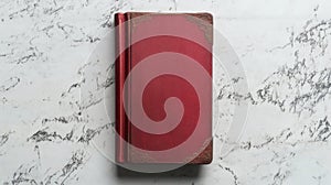 A single red book on a white surface