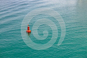 Single red buoy in the clear sea