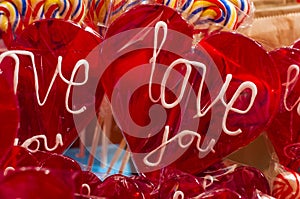 Single red candy lollypop with white text. an i love you lolly with clipping path