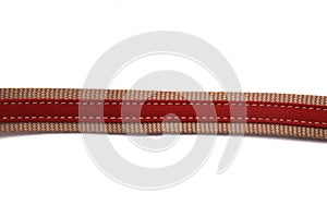 A single red canvas material fabric belt strap against a white backdrop