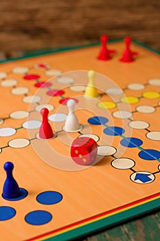 Single red dice on Ludo board