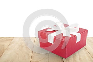 single red gift box with white ribbon bow on table floor isolated on white background with copy space