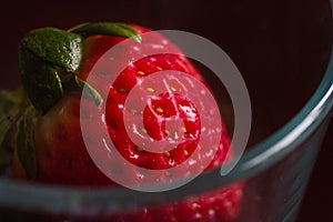 A single, red, organic strawberry.