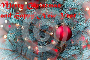 Single Red Ornament hanging from pine tree with glowing lights  in vinatage format plus text