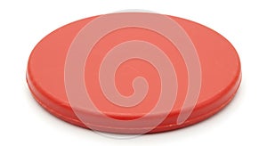 Single red plastic disc on white background