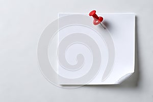 Single red pushpin on white note