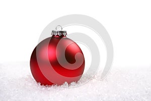 Single Red Shiny Christmas Ornament in the Snow