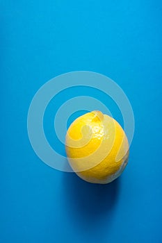 Single Ripe Juicy Whole Lemon on Blue Background. Vitamins Healthy Diet Summer Superfoods