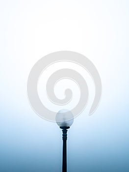 Single Round Lamp on a Black Pole