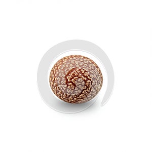 A single round object with a brown, textured surface, featuring a pattern resembling