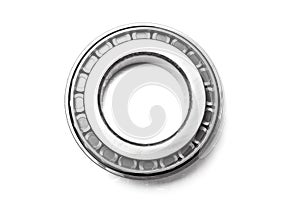 Single row tapered roller bearing made of shiny metal is designed to absorb radial and one-sided axial loads of a vehicle. Spare