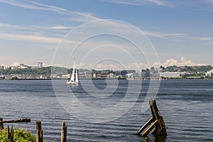 Single sailboat, sailing on Cardiff Bay, on a clear summers morning.